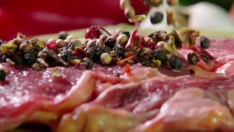 Spices are poured onto the surface of the beef Stock Footage 302109659