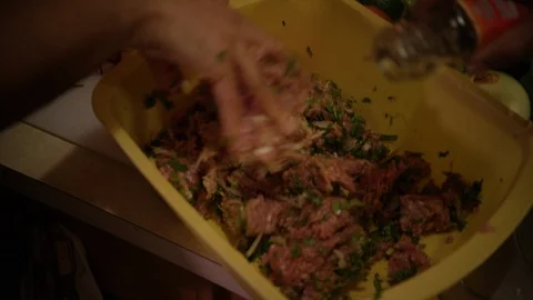 Spices being sprinkled into pot as hand stirs and prepares ground beef mixtu Stock Footage 123737773