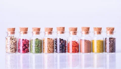 Spices in bottles on white background Stock Photos