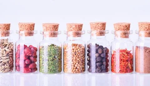 Spices in bottles on white background Stock Photos