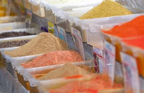Spices on the counter in plastic containers Stock Photos