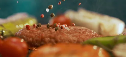 Spices dropping on burger patty Stock Footage 311833802