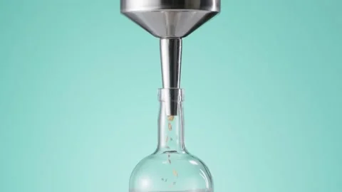 Spices falling into bottle through the funnel Stock Footage 145791446