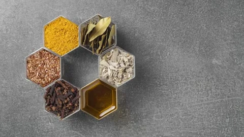 Spices in hexagonal jars on a stone surface. Stop motion animation Stock Footage 142462639