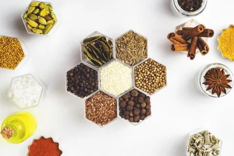 Spices in hexagonal jars on a white background Stock Photos