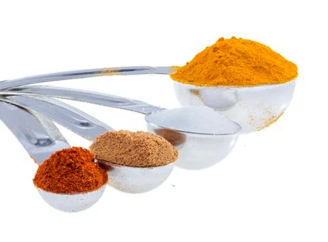 Spices in measuring spoons. Stock Photos