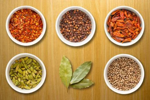 Spices in Pots on a Pine Work Surface 写真素材