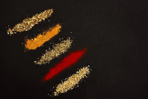 Spices scattered on a black background Stock Photos