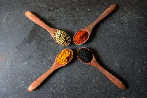 Spices on spoon Stock Photos