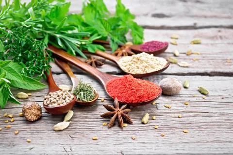 Spices in spoons on board Stock Photos