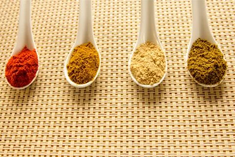 Spices in spoons on the table. Фото