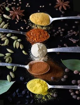 Spices in teaspoons with beautiful serving on the table Stock Photos