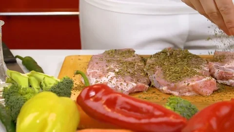 Spicing fresh raw meat in slow motion Stock Footage 85357631