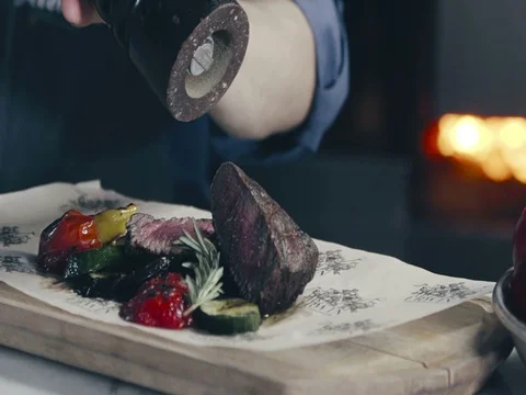Spicing Grilled beef steak on the plate with vegetables Video stock 70738929