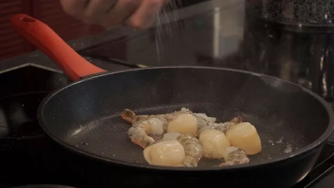 Spicing shrimp and scallops Stock Footage 112127197