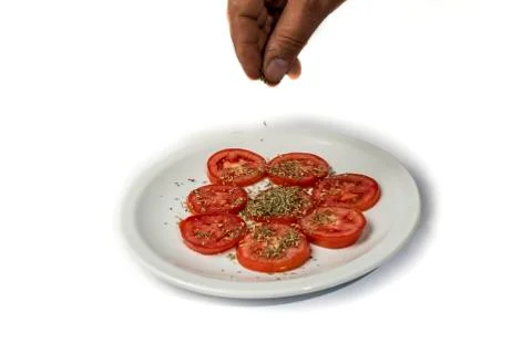 Spicing tomatoes with oregano Foto stock