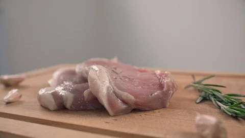 Spicing of two pieces of pork loin Stock Footage 89636308