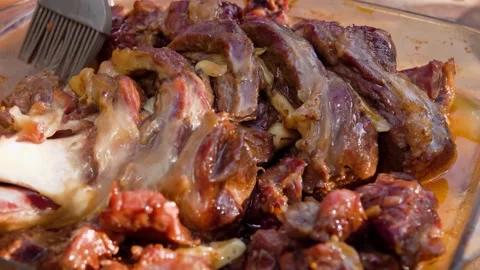 Spicy and appetizing baked lamb is drizzled with gravy. Top view. Video stock 334337240