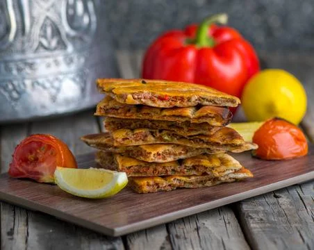 Spicy arrayes served in wooden board side view on wooden table background 写真素材