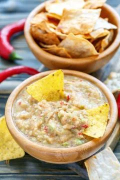 Spicy avocado dip with corn chips. Stock Photos