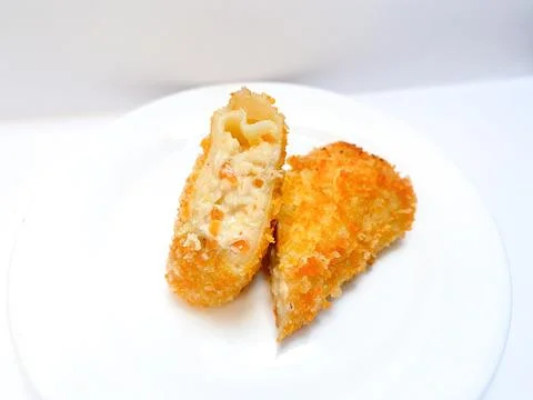 Spicy chicken risoles served on white plate. Stock Photos