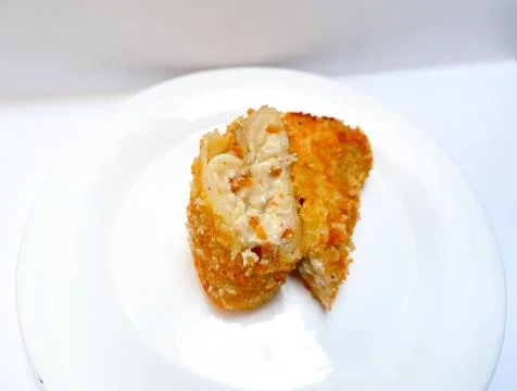 Spicy chicken risoles served on white plate. Stock Photos