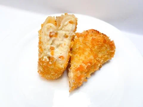 Spicy chicken risoles served on white plate. Stock Photos