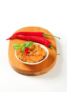 Spicy chili paste with fresh red peppers on wood 写真素材