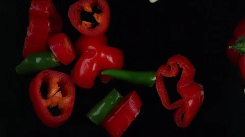 Spicy chilly peppers falling on black. Food background Stock Footage 83496829