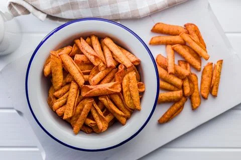 Spicy Corn Snack Chips in White Bowl on Cutting Board, Seasoned Crispy Fing.. Stock Photos