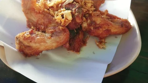 Spicy deep fried chicken wings with fried garlic. Stock Footage 103467385