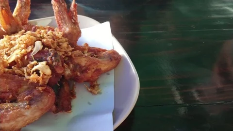 Spicy deep fried chicken wings with fried garlic. Panning left shot. Stock Footage 107092229