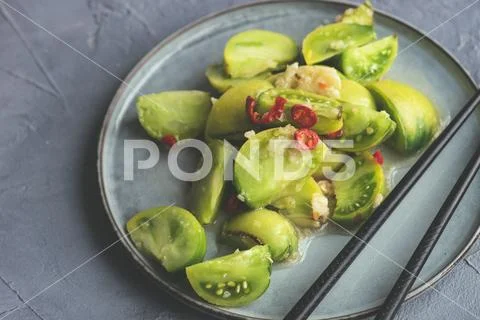Spicy green tomato salad Stock Photos