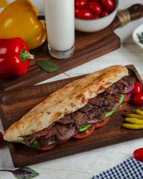 Spicy meat in bread with vegetables Stock Photos