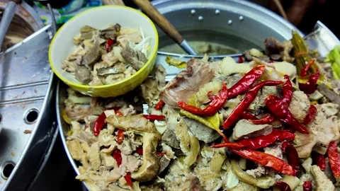 Spicy Mixed Pork Offal Served from Large Cooking Pot at Thai Street Food Market Видео 339650384