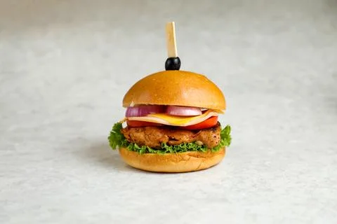 Spicy Naga Beef burger include cheese slice, tomato, onion and lettuce leaf.. Foto stock