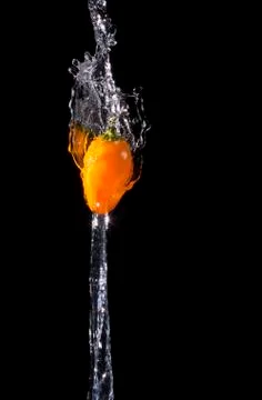 Spicy Peppers being splashed with water. Stock Photos