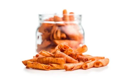 Spicy Rolled Corn Chips Stack Closeup On White Background For Snack Food Ad.. Stock Photos