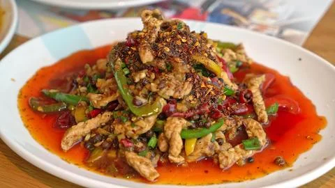 Spicy stir-fried beef with vegetables on a white plate Stock Photos