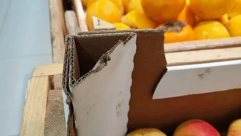 Spider crawls on a box of apples in a supermarket, unsanitary in a grocery store Stock Footage