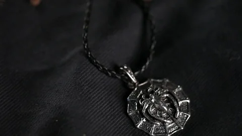 The spider crawls on a silver amulet Stock Footage 76623118