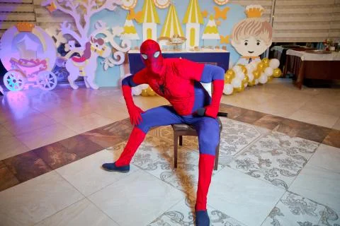 Spider-Man model display sitting on the table . A boy dressed as a spiderman  Foto stock