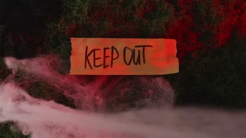 Spider shadow falling on Keep Out sign under red and blue light Stock-Footage 342520352