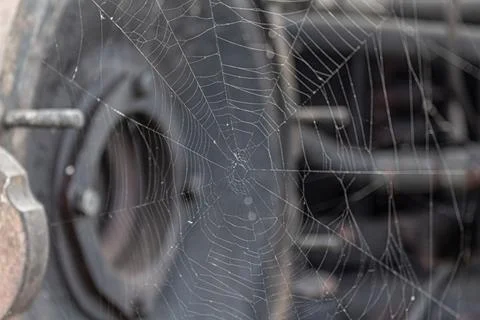 Spider web on abandoned broken old rusty forgotten technics machine mechanism Stock Photos