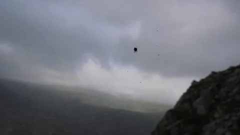 A spider web blowing in the wind with mountain cloud background Stock Footage 139972442