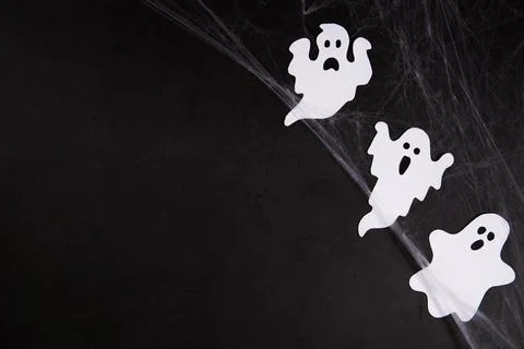 Spider web with ghosts on black background Stock Photos