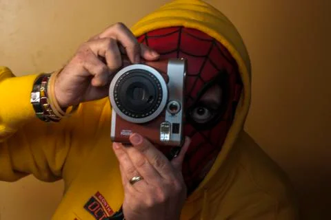 Spiderman taking a photo with a camera Stock Photos