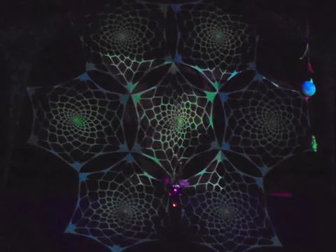 Spiderweb light art installation, UV glow on a summer night Stock Photos