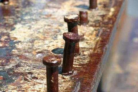 Spikes coming out of an old rusty beam Stock Photos