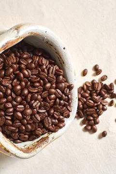 Spilled coffee beans from ceramic Stock Photos